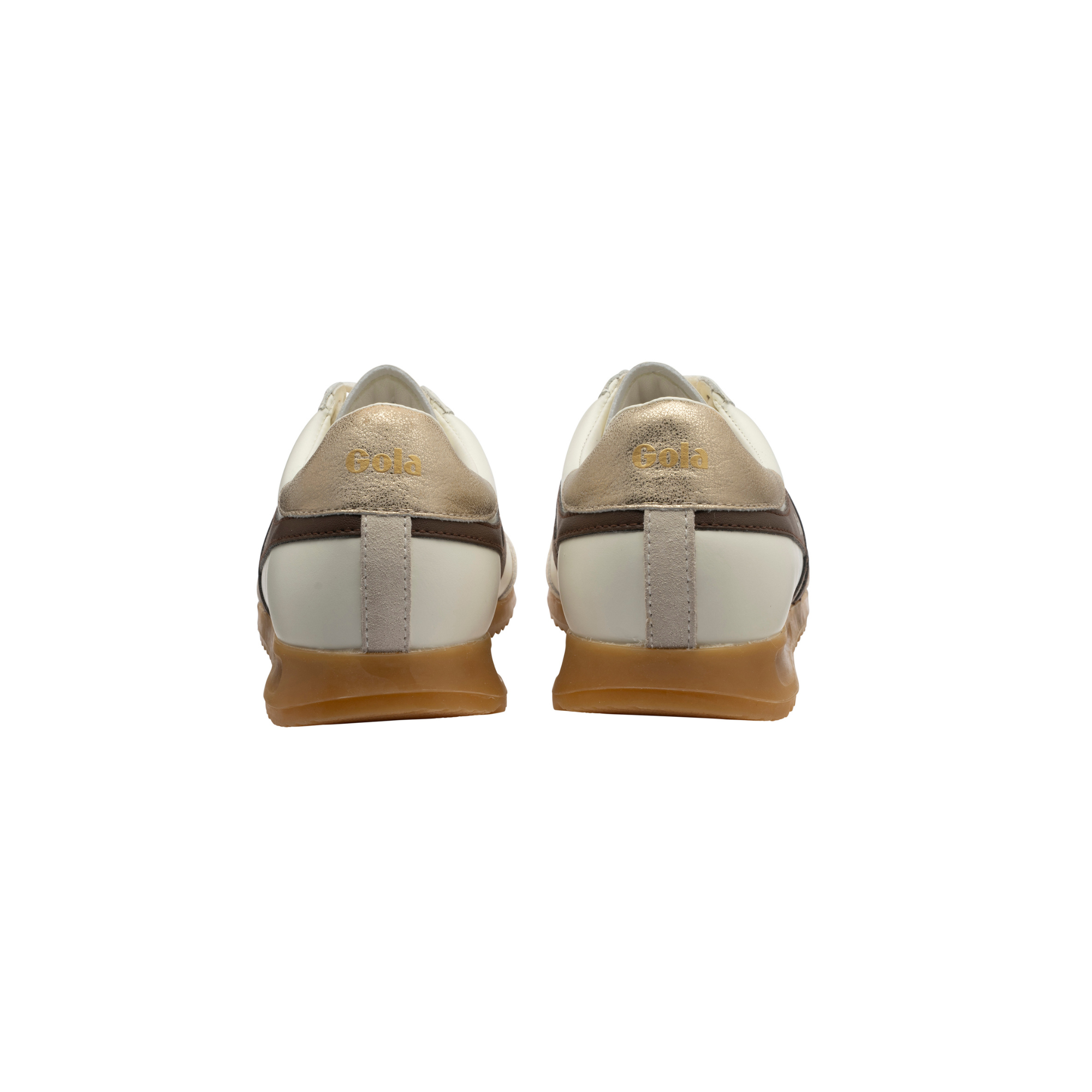 A pair of low-top sneakers shown from the back, featuring metallic gold and off-white leather uppers with dark brown stripes and gum soles.