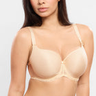 Woman wearing a beige bra and panties set on a plain background